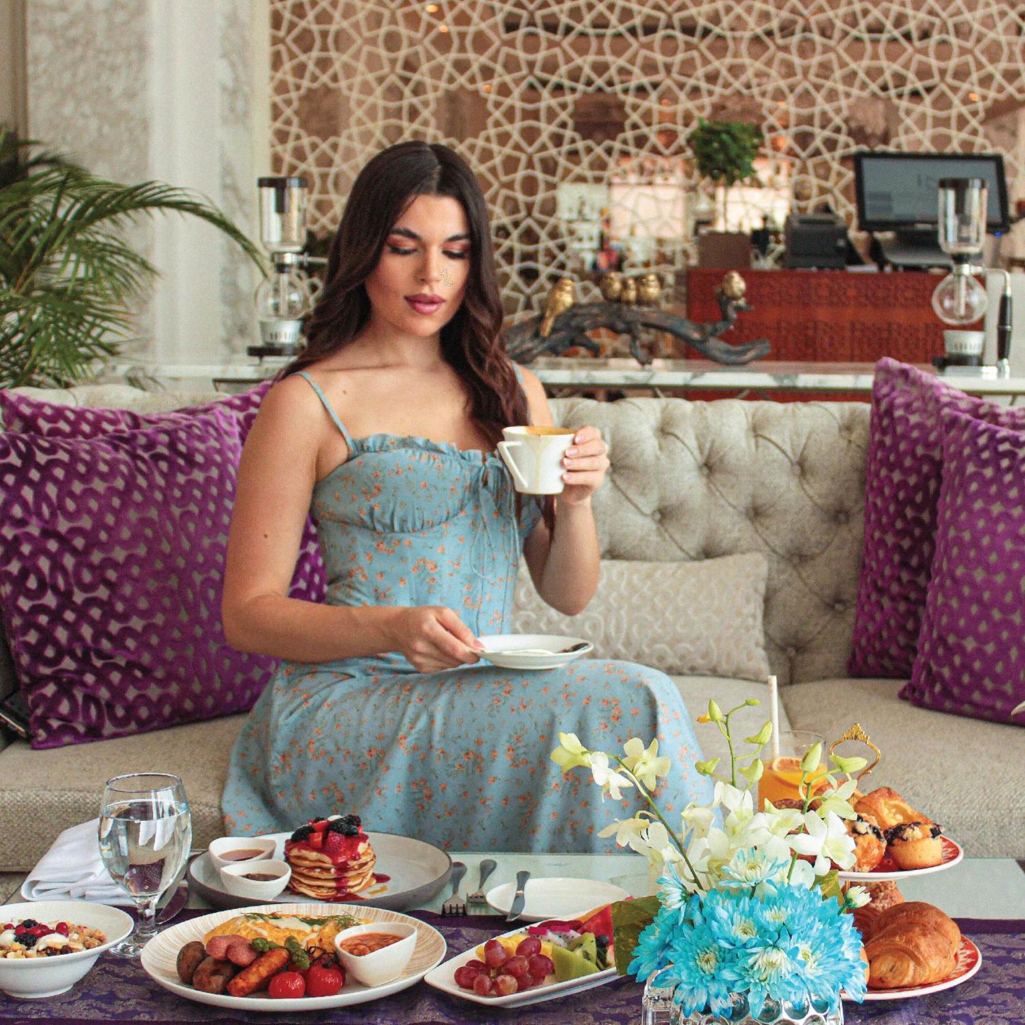 Royal Saray Resort Manama Exterior photo A woman drinking tea
